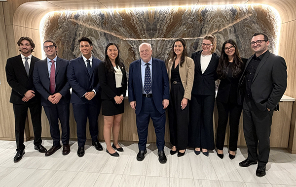 Clinic students and Professor Hoffman in professional attire at the U.S. Supreme Court